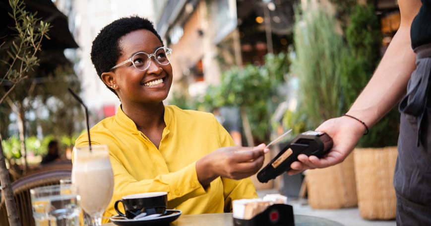 Woman paying for coffee with credit card