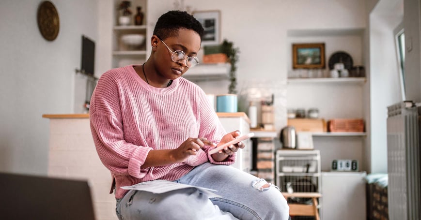 Woman calculating finances on her phone