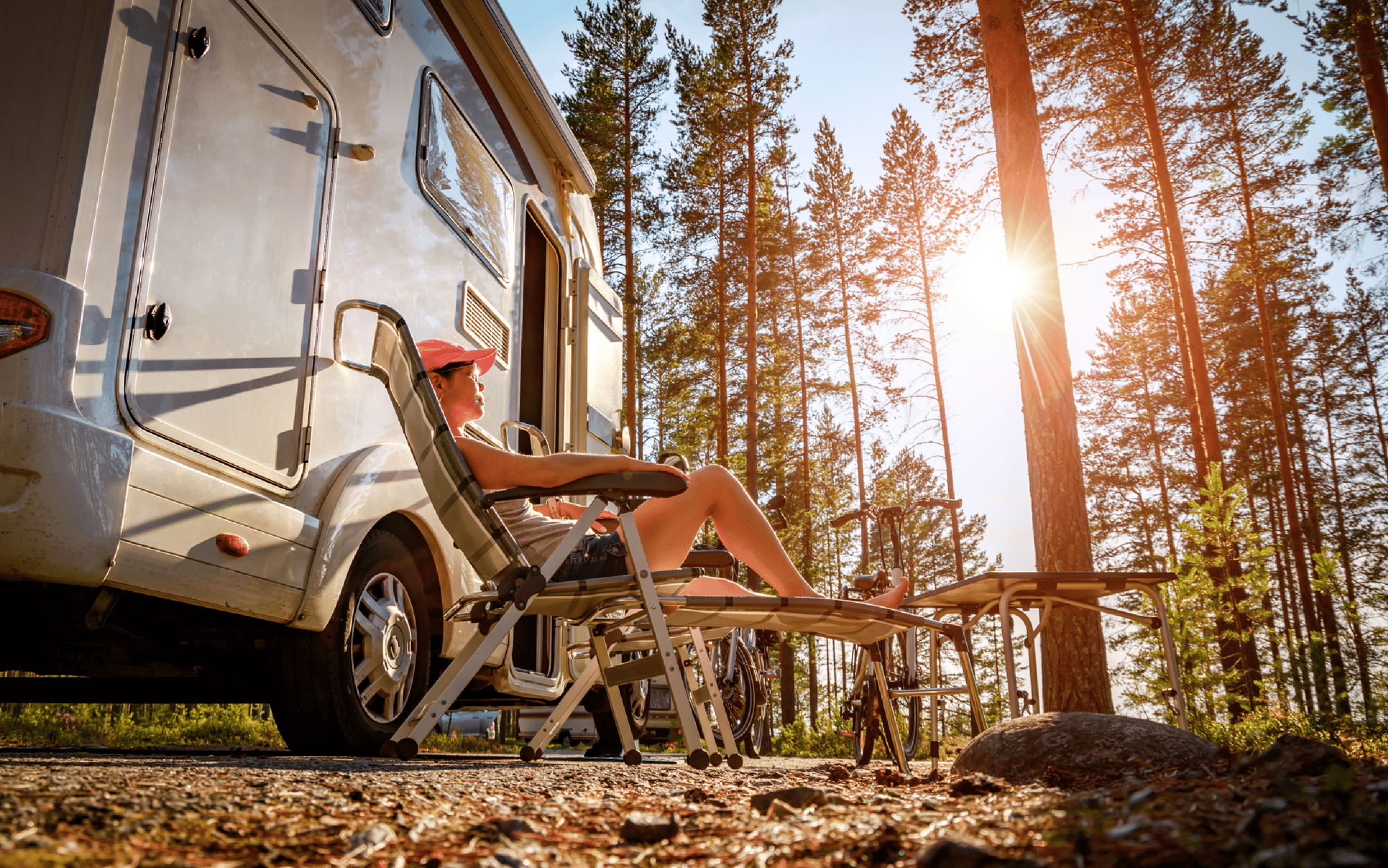 Woman relaxing outside camper