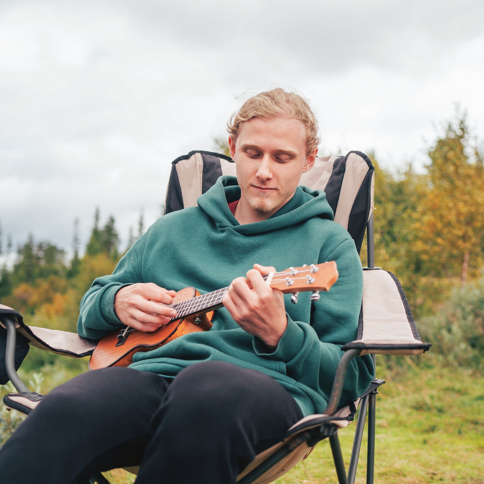Man strumming on his ukulele