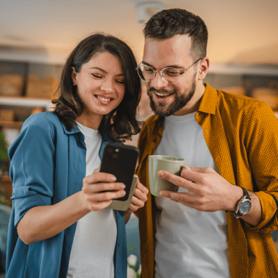 young-couple-smiling-at-phone
