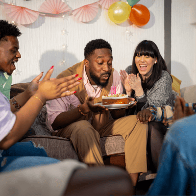 Friends blowing out birthday candles