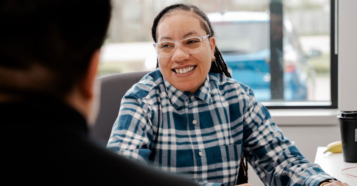 CCCU employee talking with member at desk