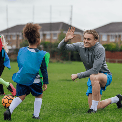 coach-high-fiving-soccer-player