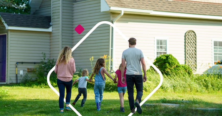 family walking towards home backs facing camera