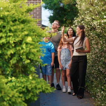 real estate agent walking with family