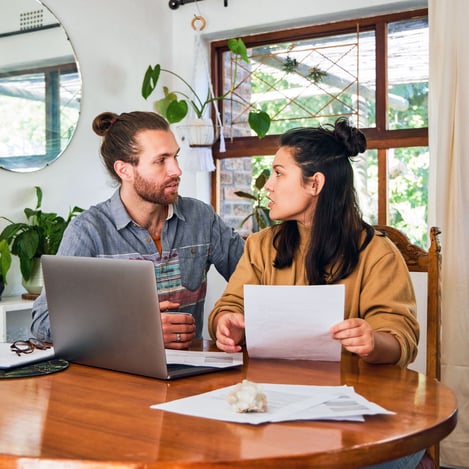 Couple checking their finances on laptop