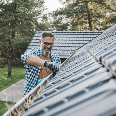 Man repairing roof gutters