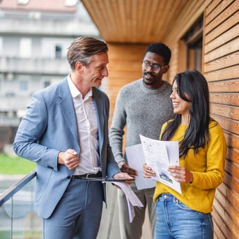 Couple touring home and talking to realtor