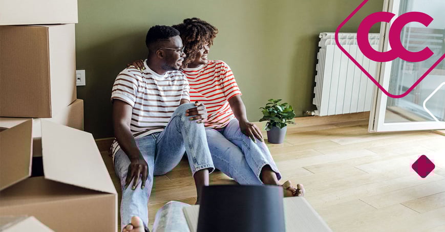 First-time home buyers sitting on the floor of their new home