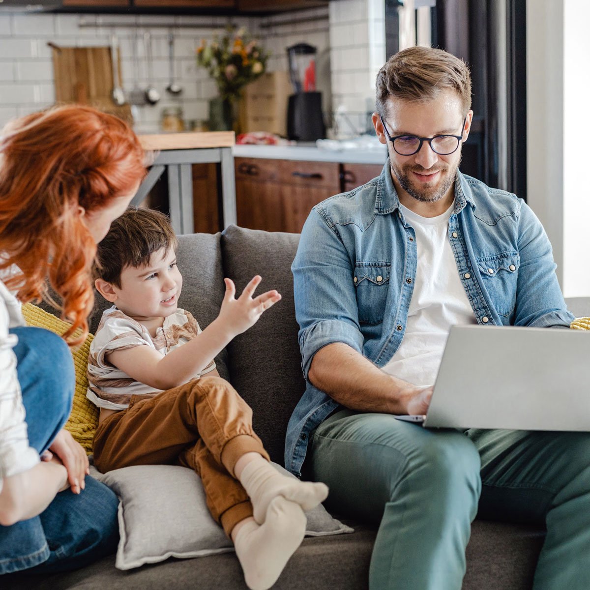 Family sitting on couch together