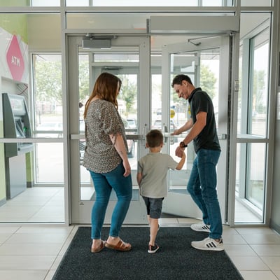 Family walking out of a CCCU branch