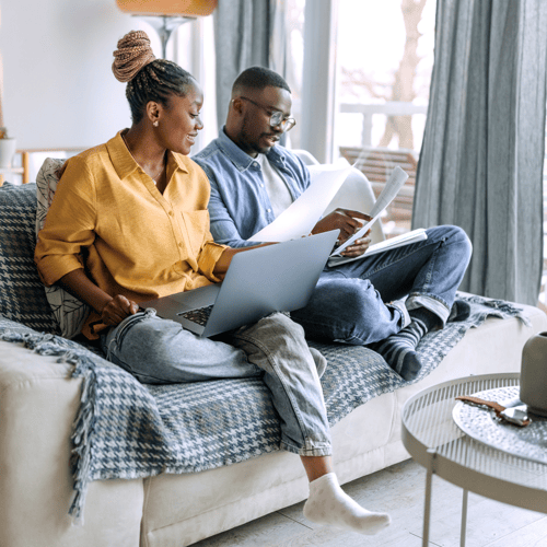 couple on couch calculating loan rates