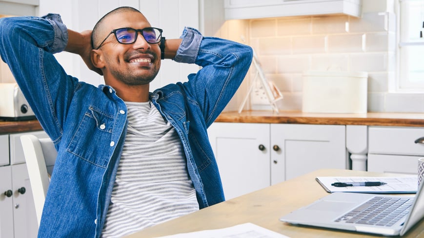 Man sitting at table building a saving money plan