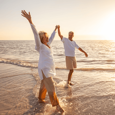 Retired couple walking on the beach