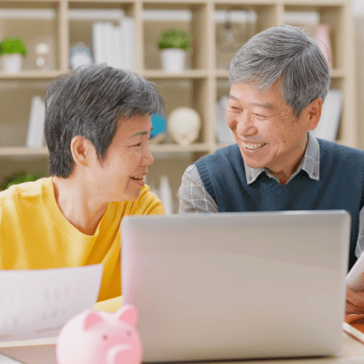 Retired couple planning finances at computer