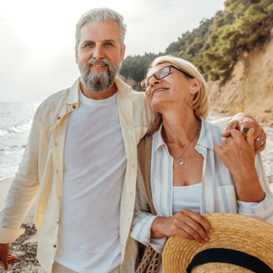 Retired couple walking on the beach