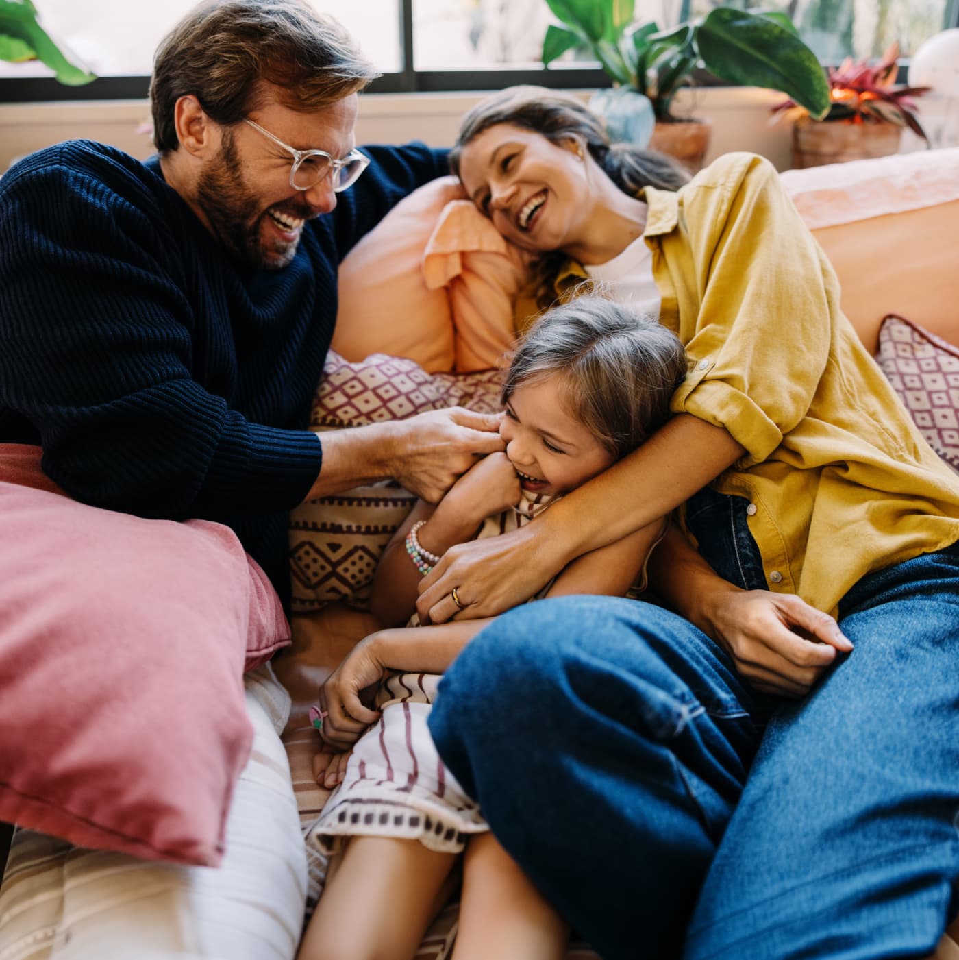 Family laughing together on couch