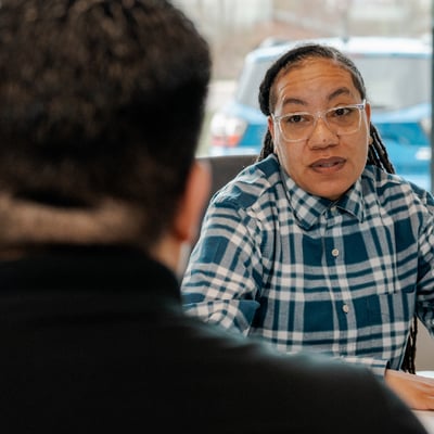 CCCU employee speaking with member in office