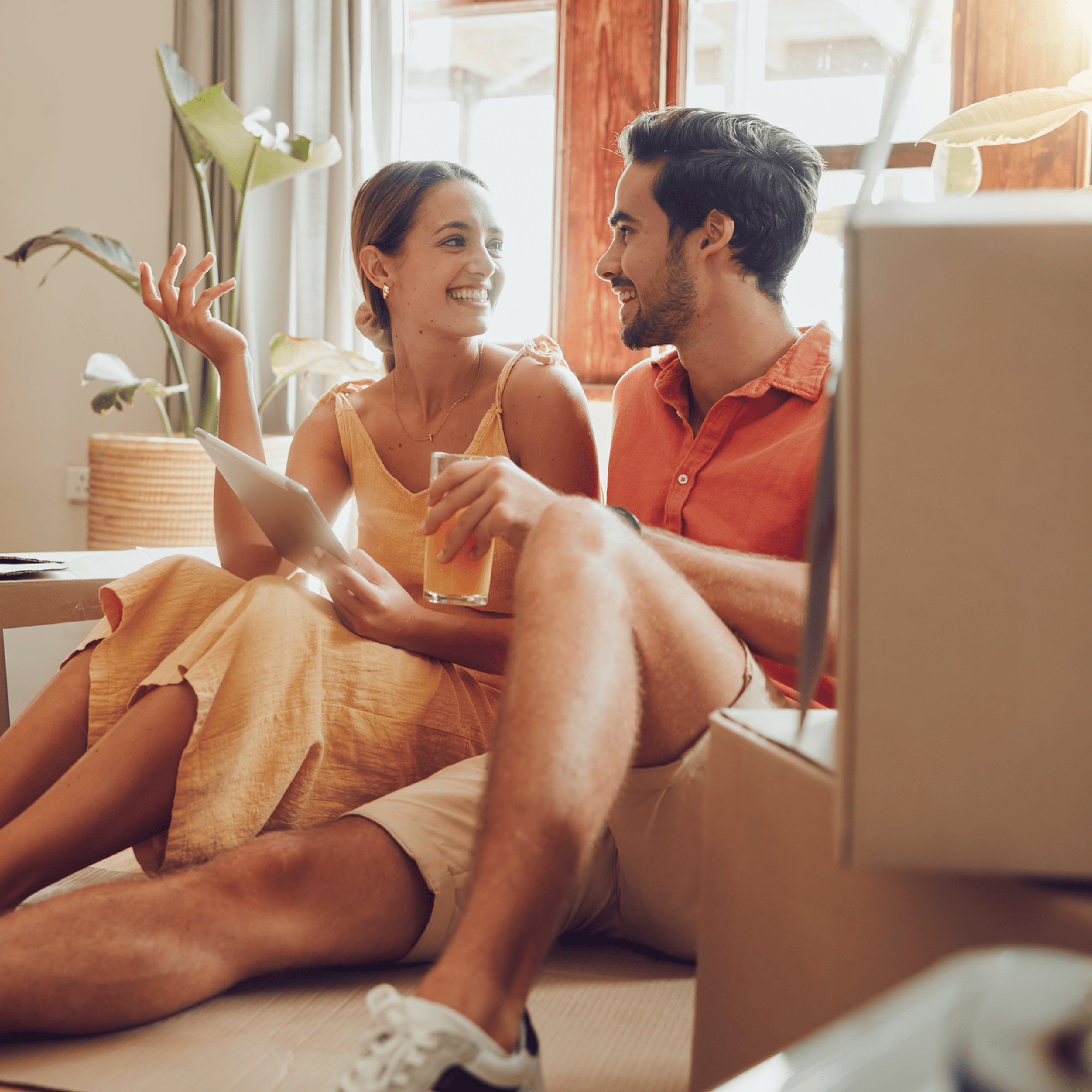 Couple searching for home together on couch 