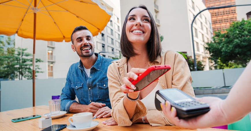 Woman using digital payment at coffee shop