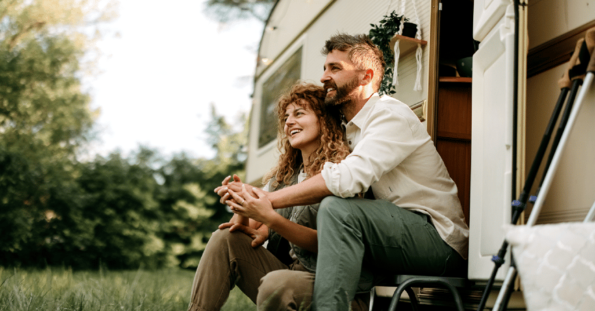 Couple sitting outside camper
