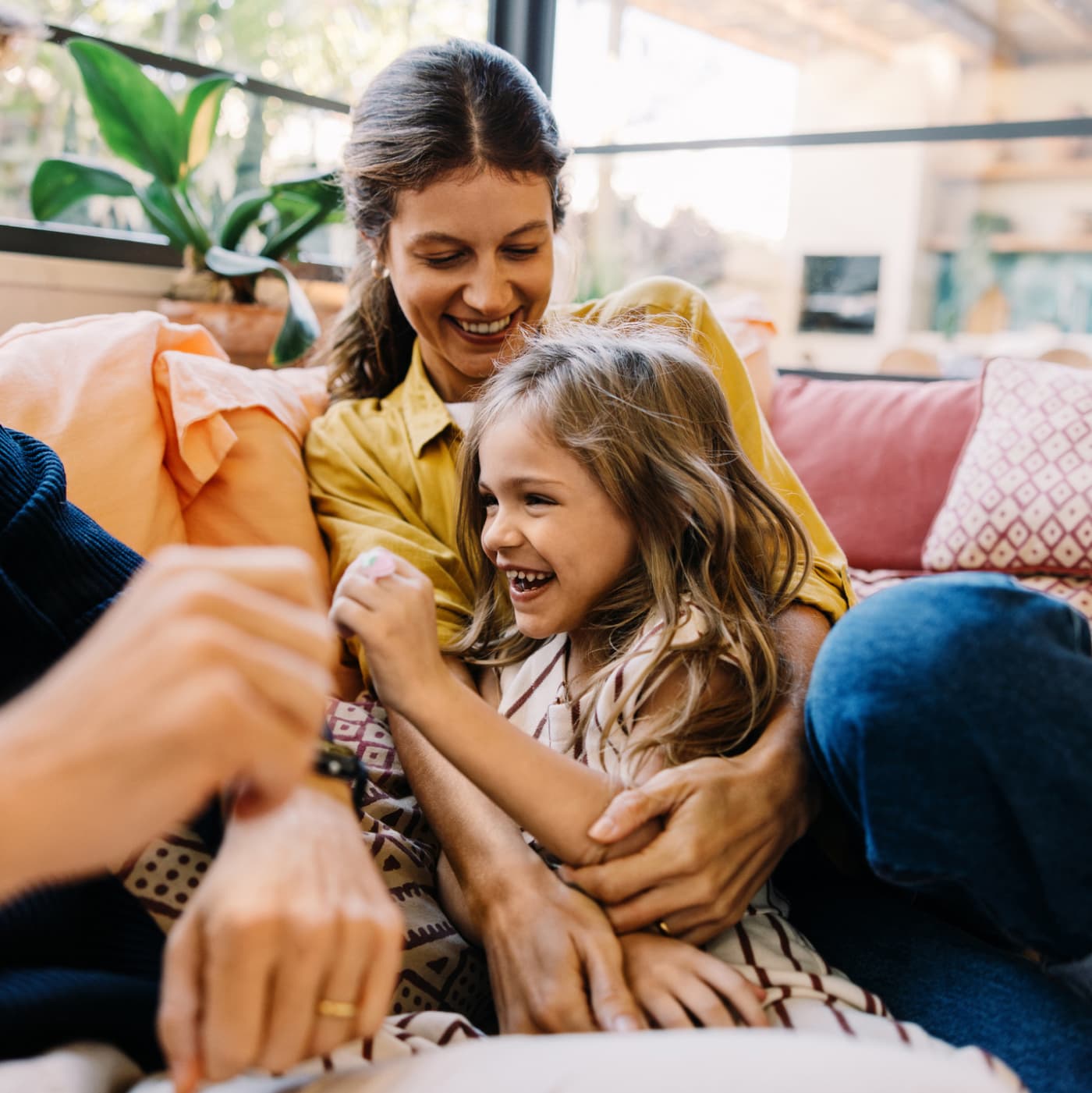 family-together-on-pink-couch-in-modern-living-room