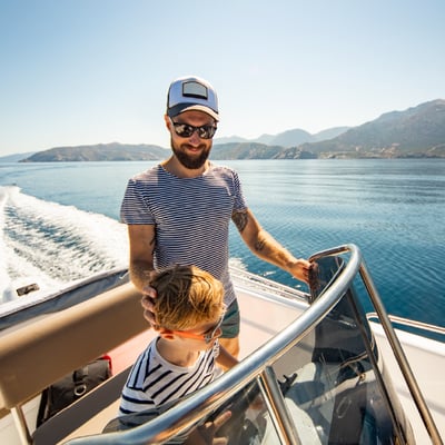 Father and son driving boat