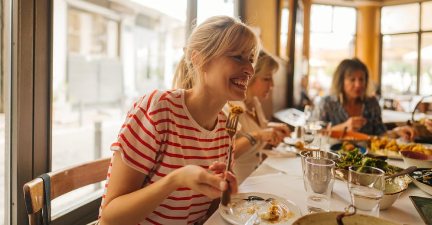 Woman sitting at table with friends