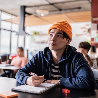 college student taking notes in class