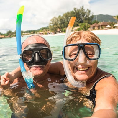 Selfie of retired couple snorkling in the ocean