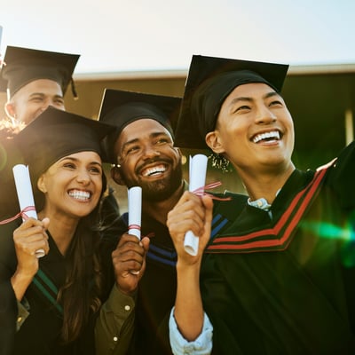 college graduates taking selfie with diplomas