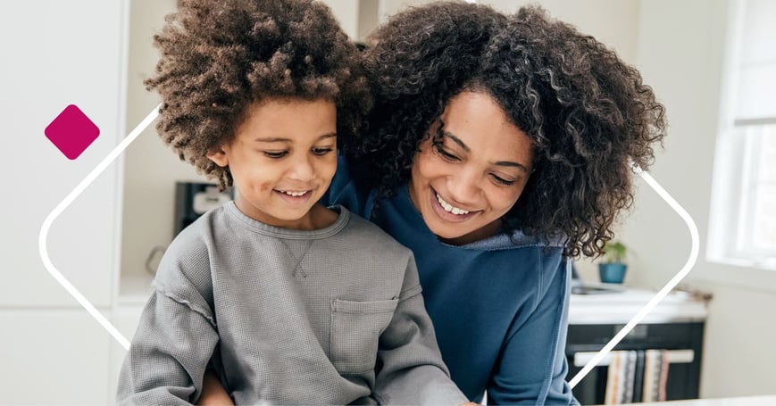 Mother and son sitting at table together