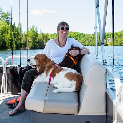 Woman with dogs on boat